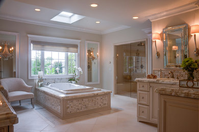 Inspiration for a timeless beige tile and stone tile marble floor bathroom remodel in Other with an undermount sink, raised-panel cabinets, beige cabinets, marble countertops, a one-piece toilet and beige walls