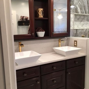 Master Bath w/ custom Mahogany cabinets, large porcelain tiles and marble tiles