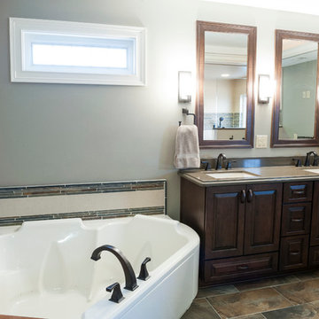 Master Bath with Dark Wood Cabinets, Quartz Countertops, and Jetted Tub
