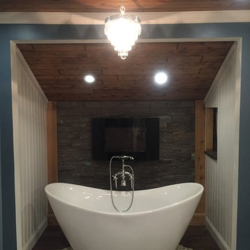 Master Bath with fireplace, stacked stone wall, cedar ceiling and chandelier