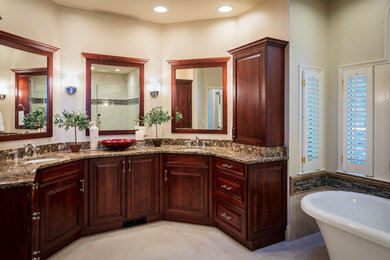 This is an example of a large classic ensuite bathroom in Atlanta with raised-panel cabinets, dark wood cabinets, a freestanding bath, a built-in shower, a two-piece toilet, beige tiles, porcelain tiles, beige walls, porcelain flooring, a submerged sink, engineered stone worktops, beige floors and a hinged door.