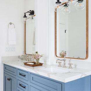 Inspiration for a mid-sized contemporary master beige tile and subway tile porcelain tile and white floor bathroom remodel in Los Angeles with an undermount sink, shaker cabinets, blue cabinets, white walls, marble countertops and a hinged shower door
