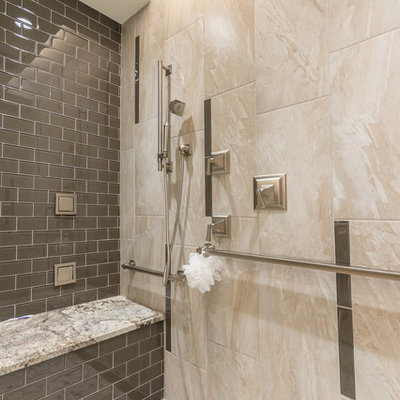 Inspiration for a mid-sized timeless master gray tile and glass tile porcelain tile walk-in shower remodel in Austin with an undermount sink, raised-panel cabinets, medium tone wood cabinets, granite countertops and beige walls