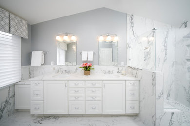 Inspiration for a large traditional ensuite bathroom in DC Metro with recessed-panel cabinets, white cabinets, a claw-foot bath, an alcove shower, a two-piece toilet, white tiles, porcelain tiles, grey walls, terracotta flooring, a submerged sink, engineered stone worktops, white floors, a hinged door, white worktops, a wall niche, double sinks, a built in vanity unit, a vaulted ceiling and wainscoting.