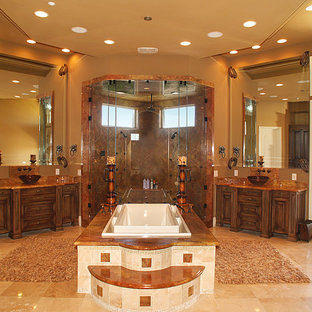 Photo of an expansive mediterranean master bathroom in Las Vegas with brown cabinets, a claw-foot tub, a double shower, beige walls, brick floors, an integrated sink, beige floor, a hinged shower door, brown benchtops, a double vanity, a built-in vanity and vaulted.