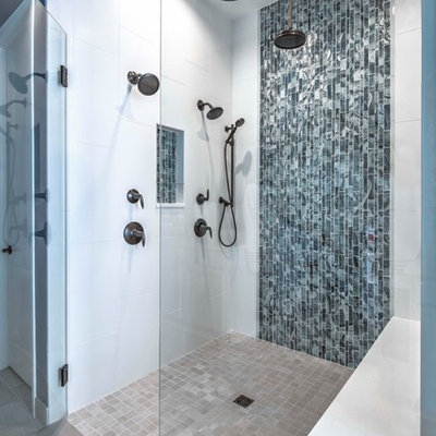 Example of a mid-sized trendy master blue tile and glass tile beige floor alcove shower design in Denver with blue walls and a hinged shower door