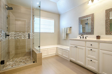 Corner shower - large traditional master beige tile pebble tile floor corner shower idea in Austin with an undermount sink, recessed-panel cabinets, white cabinets and beige walls