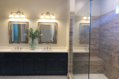 Example of a large cottage master brown tile and porcelain tile cement tile floor bathroom design in Phoenix with raised-panel cabinets, dark wood cabinets, a two-piece toilet, beige walls, an undermount sink, quartz countertops and white countertops