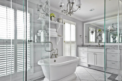 Inspiration for a large transitional master white tile white floor bathroom remodel in Other with recessed-panel cabinets, white cabinets, white walls, an undermount sink and a hinged shower door