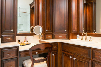 Large elegant master marble tile marble floor bathroom photo in Charleston with raised-panel cabinets, dark wood cabinets, a one-piece toilet, a drop-in sink, marble countertops, a hinged shower door and white countertops