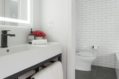 Inspiration for a mid-sized contemporary master white tile and subway tile ceramic tile, gray floor and single-sink alcove bathtub remodel in Boston with a two-piece toilet, a console sink, a niche and white walls