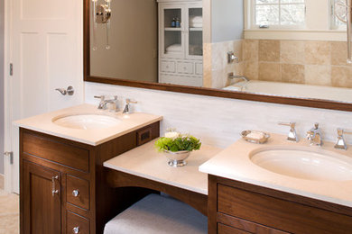 Design ideas for a traditional bathroom in Minneapolis with a submerged sink, dark wood cabinets and beige tiles.