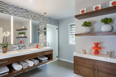 Walk-in shower - mid-sized contemporary master gray tile and mosaic tile porcelain tile and gray floor walk-in shower idea in Providence with flat-panel cabinets, medium tone wood cabinets, gray walls, an undermount sink, quartz countertops and a hinged shower door