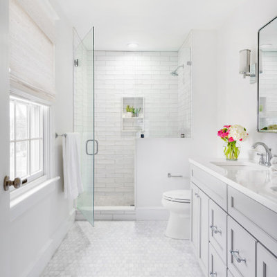 Mid-sized transitional master porcelain tile and white tile marble floor and white floor alcove shower photo in Philadelphia with gray cabinets, white walls, a hinged shower door, recessed-panel cabinets, an undermount sink and white countertops