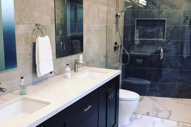 Design ideas for a medium sized contemporary ensuite wet room bathroom in San Francisco with freestanding cabinets, brown cabinets, a wall mounted toilet, grey tiles, porcelain tiles, grey walls, porcelain flooring, an integrated sink, marble worktops, white floors, a hinged door and white worktops.