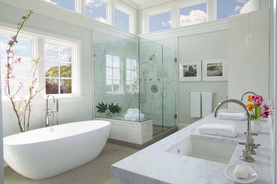 Example of a large transitional master gray tile, white tile and marble tile porcelain tile and beige floor bathroom design in New York with a two-piece toilet, white walls, an undermount sink, marble countertops, a hinged shower door, flat-panel cabinets and white cabinets