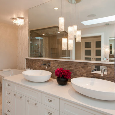 Example of a large trendy brown tile bathroom design in Vancouver with a vessel sink, recessed-panel cabinets and white cabinets