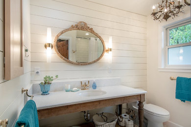 Inspiration for a small coastal master white tile alcove shower remodel in San Francisco with white walls, a one-piece toilet, a console sink and quartz countertops
