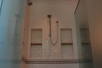 Example of a large 1950s master white tile and ceramic tile marble floor double shower design in Milwaukee with an undermount sink, raised-panel cabinets, medium tone wood cabinets, granite countertops, an undermount tub, a two-piece toilet and white walls