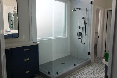 Example of a large minimalist master ceramic tile and multicolored floor doorless shower design in Los Angeles with flat-panel cabinets, blue cabinets, white walls, an undermount sink, quartz countertops, a hinged shower door and white countertops
