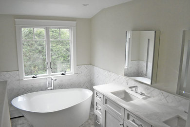 Inspiration for a mid-sized transitional master double-sink japanese bathtub remodel in Boston with gray cabinets, marble countertops, beige countertops and a floating vanity