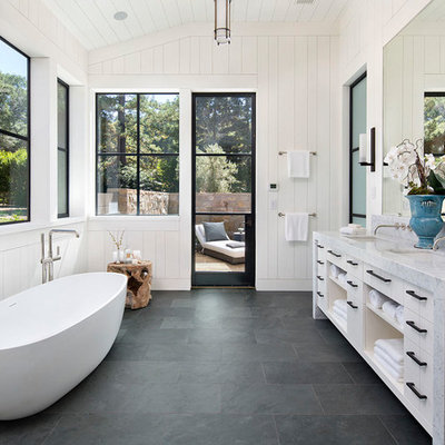 Inspiration for a farmhouse master gray floor and slate floor freestanding bathtub remodel in San Francisco with open cabinets, white cabinets, white walls, an undermount sink and marble countertops