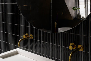 Photo of a large contemporary bathroom in London with a freestanding bath, a wall mounted toilet, black tiles, porcelain tiles, black walls, marble flooring, a wall-mounted sink, grey floors and an open shower.
