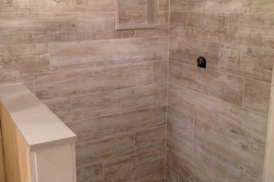 Mid-sized elegant master beige tile and ceramic tile pebble tile floor tub/shower combo photo in New York