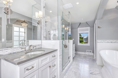 Inspiration for a mid-sized transitional master gray tile, white tile and subway tile marble floor and gray floor bathroom remodel in Phoenix with shaker cabinets, white cabinets, gray walls, an undermount sink, quartz countertops and gray countertops