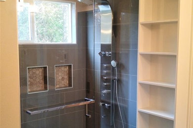 Mid-sized transitional master gray tile and porcelain tile porcelain tile and brown floor corner shower photo in Seattle with beige walls and a hinged shower door