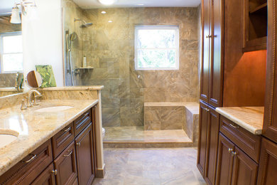 Inspiration for a mid-sized timeless master beige tile and ceramic tile ceramic tile walk-in shower remodel in Baltimore with an undermount sink, flat-panel cabinets, medium tone wood cabinets, granite countertops, a two-piece toilet and beige walls