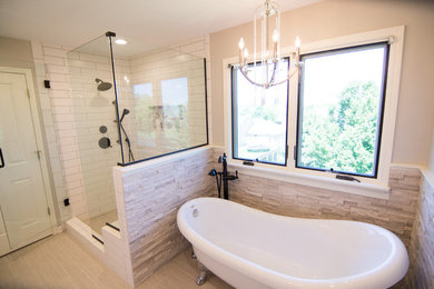 Bathroom - mid-sized traditional master beige tile and stone tile porcelain tile and beige floor bathroom idea in Kansas City with recessed-panel cabinets, white cabinets, a two-piece toilet, beige walls, an undermount sink, granite countertops and a hinged shower door