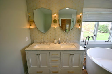 Photo of a large contemporary ensuite bathroom in Milwaukee with a submerged sink, recessed-panel cabinets, white cabinets, granite worktops, a corner bath, a corner shower, a two-piece toilet, white tiles, ceramic tiles, beige walls and ceramic flooring.