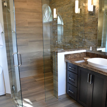 Master Bathroom Remodel with Black Cabinets, Granite Countertop, and Stone Wall