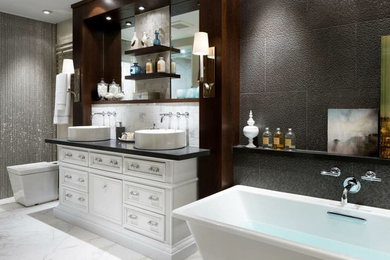 Bathroom - eclectic white tile marble floor bathroom idea in Miami with furniture-like cabinets, dark wood cabinets, a one-piece toilet, a vessel sink and granite countertops