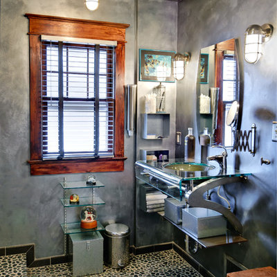 Example of a mid-sized eclectic master pebble tile, black tile and gray tile pebble tile floor alcove shower design in Philadelphia with an undermount sink, glass countertops, gray walls, open cabinets and a one-piece toilet
