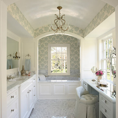 Inspiration for a large timeless master marble floor alcove bathtub remodel in Minneapolis with marble countertops, shaker cabinets, white cabinets, white walls, an undermount sink and gray countertops