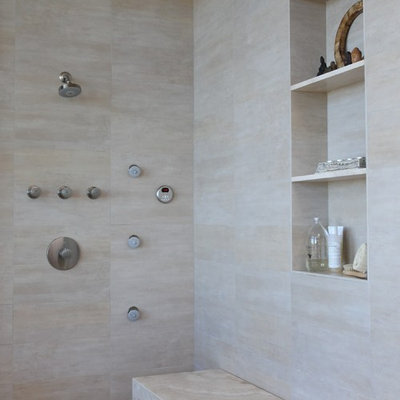 Inspiration for a contemporary beige tile pebble tile floor shower bench remodel in Los Angeles with a niche
