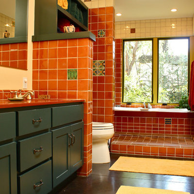 Southwest red tile bathroom photo in Santa Barbara with shaker cabinets and blue cabinets
