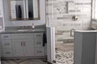 Inspiration for a coastal master gray tile bathroom remodel in Miami with shaker cabinets, white cabinets, gray walls and quartzite countertops