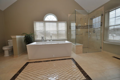 Example of a large trendy master beige tile and porcelain tile mosaic tile floor bathroom design in Philadelphia with an undermount sink, brown cabinets, granite countertops, a two-piece toilet and green walls