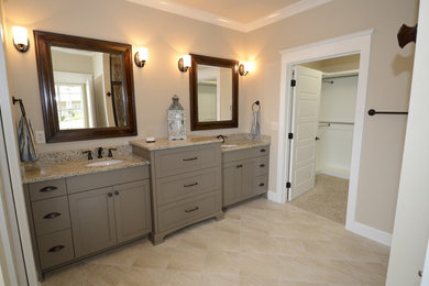 Example of a large classic master beige tile, brown tile, multicolored tile and white tile ceramic tile bathroom design in Birmingham with shaker cabinets, beige cabinets, beige walls, an undermount sink and granite countertops