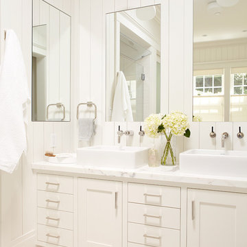 Master bathroom, white vanity with two sinks and large mirrors