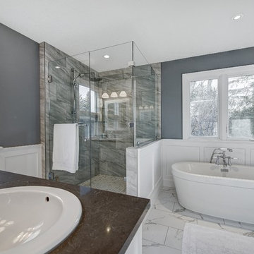 Master bathroom with custom shower enclosure, freestanding tub and wainscot pane