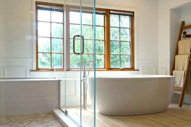 Inspiration for a large timeless master white tile and ceramic tile ceramic tile and beige floor freestanding bathtub remodel in New York with recessed-panel cabinets, brown cabinets, a two-piece toilet, white walls, an undermount sink, quartz countertops, a hinged shower door and white countertops