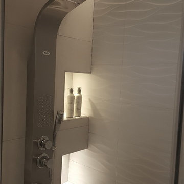 Master bathroom with TV, mirrors and corner bath