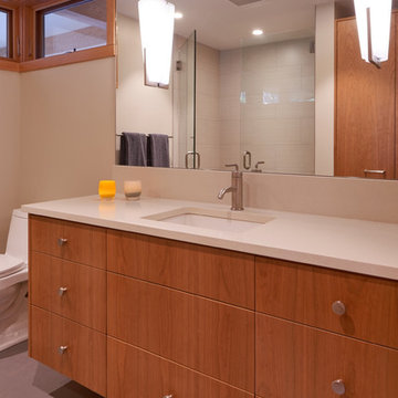 Master bathroom with vertical grain cherry vanity and quartz countertop.
