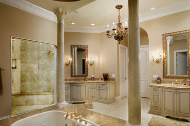 Example of a large tuscan master beige tile and stone tile porcelain tile bathroom design in Orlando with an integrated sink, beaded inset cabinets, beige cabinets, granite countertops and beige walls