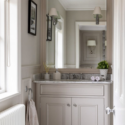 Inspiration for a mid-sized victorian master marble floor, white floor, single-sink and wall paneling bathroom remodel in Essex with beaded inset cabinets, gray cabinets, gray walls, an integrated sink, marble countertops, white countertops and a built-in vanity