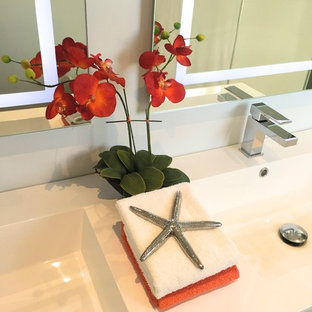 Inspiration for a medium sized classic shower room bathroom in Toronto with flat-panel cabinets, white cabinets, an alcove shower, grey tiles, porcelain tiles, white walls, porcelain flooring, an integrated sink, solid surface worktops, grey floors and a sliding door.